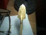 This is one of my atalatl arrowheads I made from the sections of a turtle shell, I carved it out with a piece of flint. It is fitted with pine pitch and wrapped with sinew on my atalatl shaft.