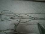 An arrow with makeshift pine needle fletching wrapped in sinew.