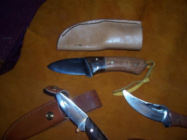 The blade peeking into the picture bottom right is the knife I hunt with.  This little monster went through 2 moose, and 4 deer this past hunting season without a sharpening and could still shave!  I didnt dull it until I used it to butcher the last two of the deer with it!